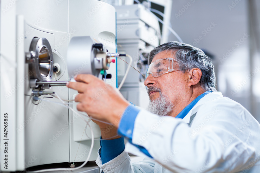 Senior male researcher carrying out scientific research in a lab Senior male researcher carrying out scientific research in a lab