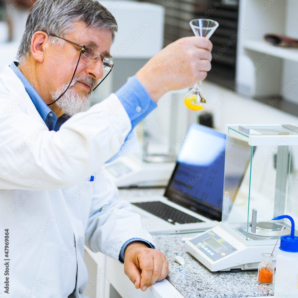 Senior male researcher carrying out scientific research in a lab Senior male researcher carrying out scientific research in a lab