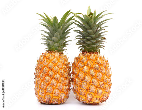 Two ripe pineapples isolated on white