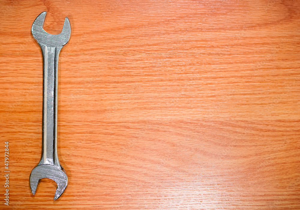 double open end wrench on wooden planks background double open end wrench on wooden planks background