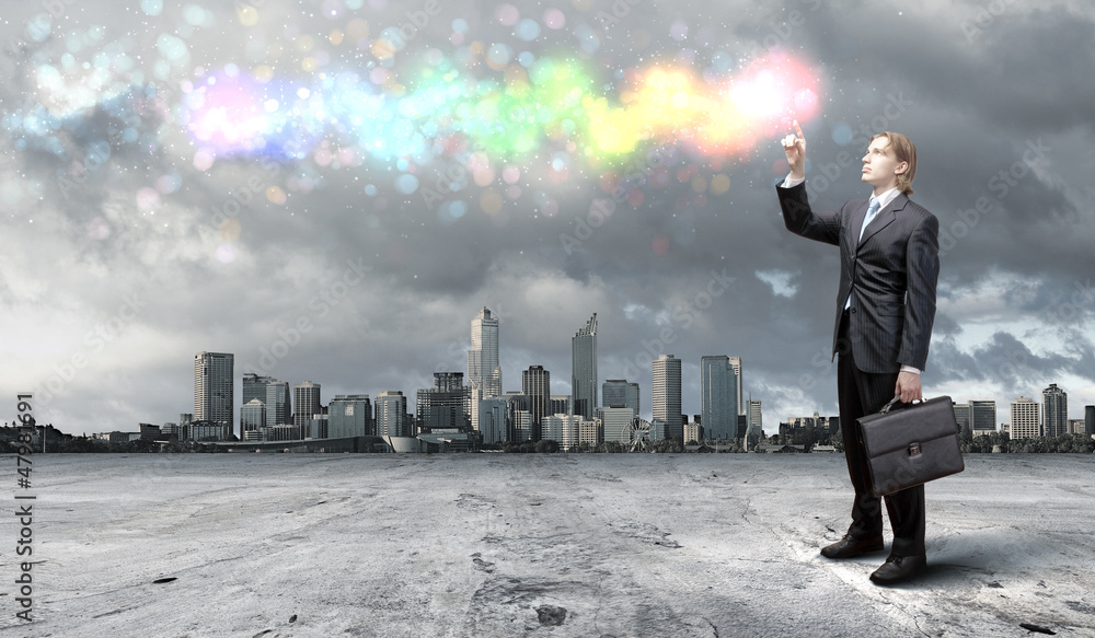Businessman with colourful light beam in his hands Businessman with colourful light beam in his hands