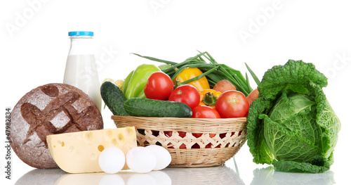 Composition with vegetables  in wicker basket isolated on white