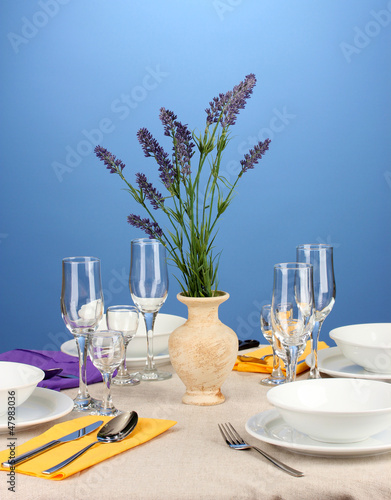 Table setting in violet and yellow tones on color background