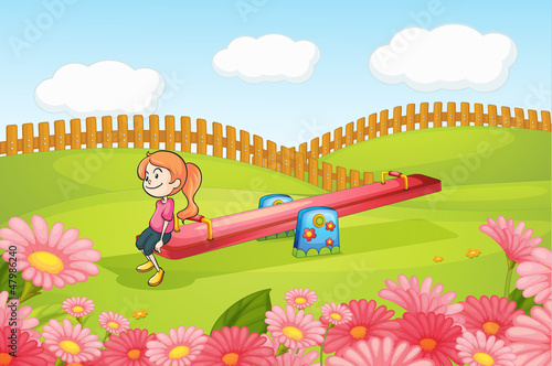 A girl playing on a seesaw