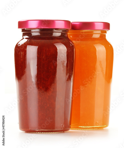 Two jars of fruity jams isolated on white. Preserved fruits