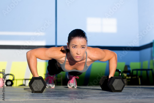 Fototapeta Naklejka Na Ścianę i Meble -  Gym woman push-up strength pushup with dumbbell