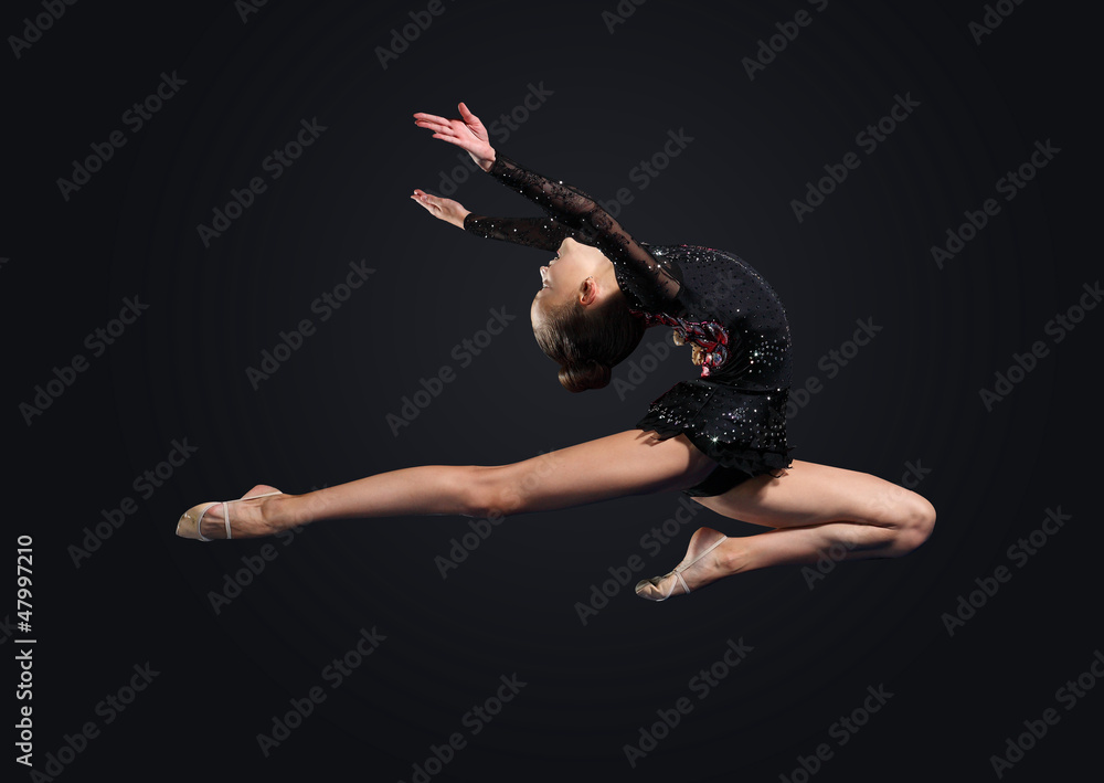 Naklejka premium Young woman in gymnast suit posing