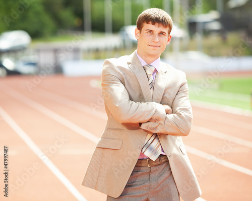 Businessman at athletic stadium and race track