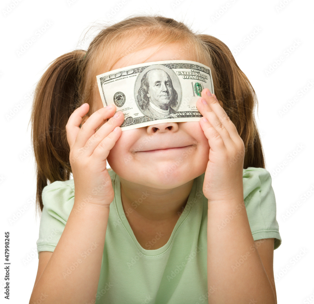 Little girl is covering her eyes with dollars Little girl is covering her eyes with dollars