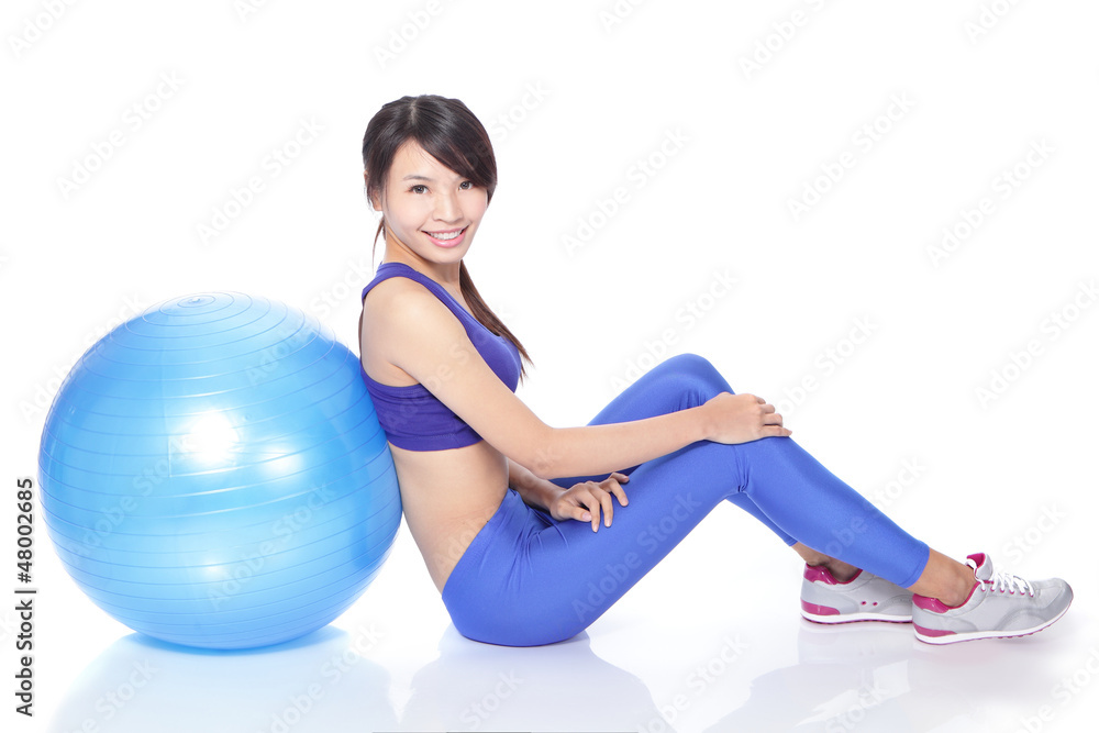 Fototapeta premium happy woman sitting on floor with fit ball