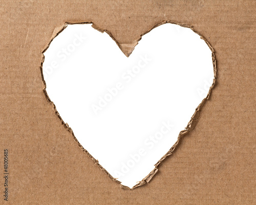 hole in a shape of heart on cardboard