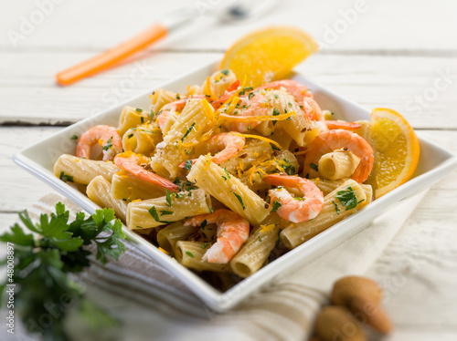 pasta with shrimp orange peel and almond, selective focus