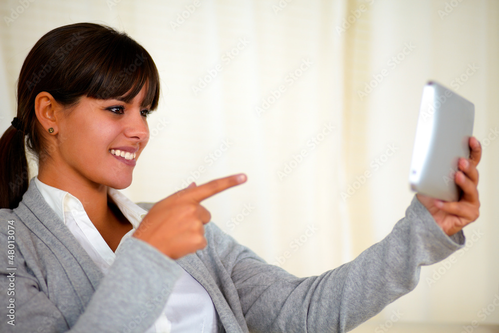 Young woman pointing the tablet pc screen Young woman pointing the tablet pc screen