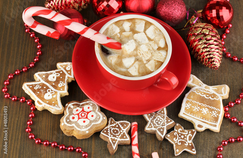 Cup of coffee with Christmas sweetness on wooden table close-up
