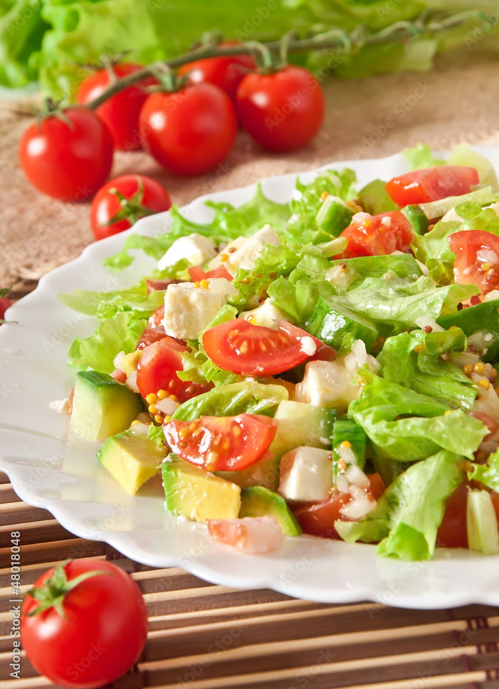 Salad with avocado, cherry tomatoes and mozzarella Salad with avocado, cherry tomatoes and mozzarella
