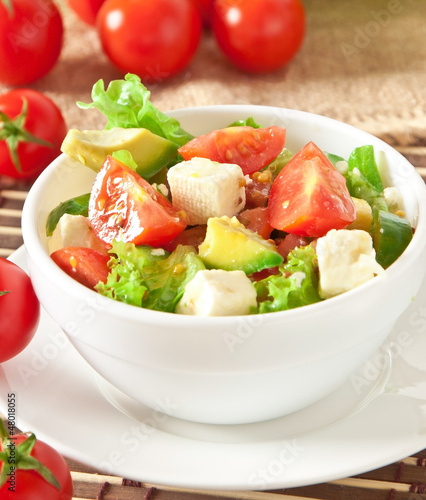 Salad with avocado, cherry tomatoes and mozzarella 