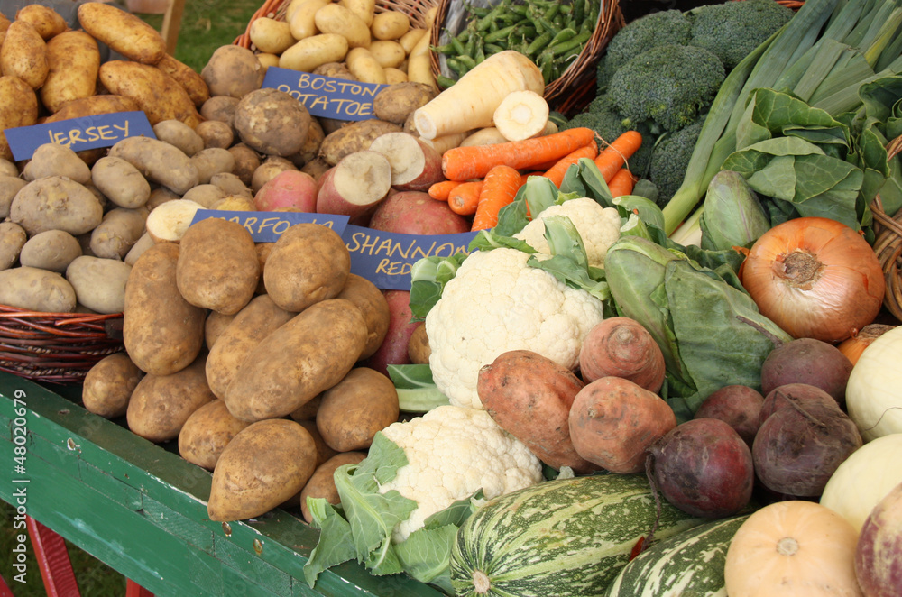 A Wooden Trolley Holding a Display of Fresh Vegetables. A Wooden Trolley Holding a Display of Fresh Vegetables.