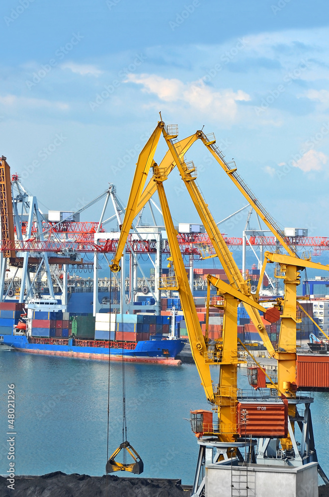 Container stack and ship under crane bridge