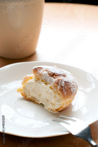 Choux pastry cream puffs on white plate