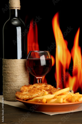 Fototapeta Naklejka Na Ścianę i Meble -  Roast chicken cutlet with french fries, glass of wine