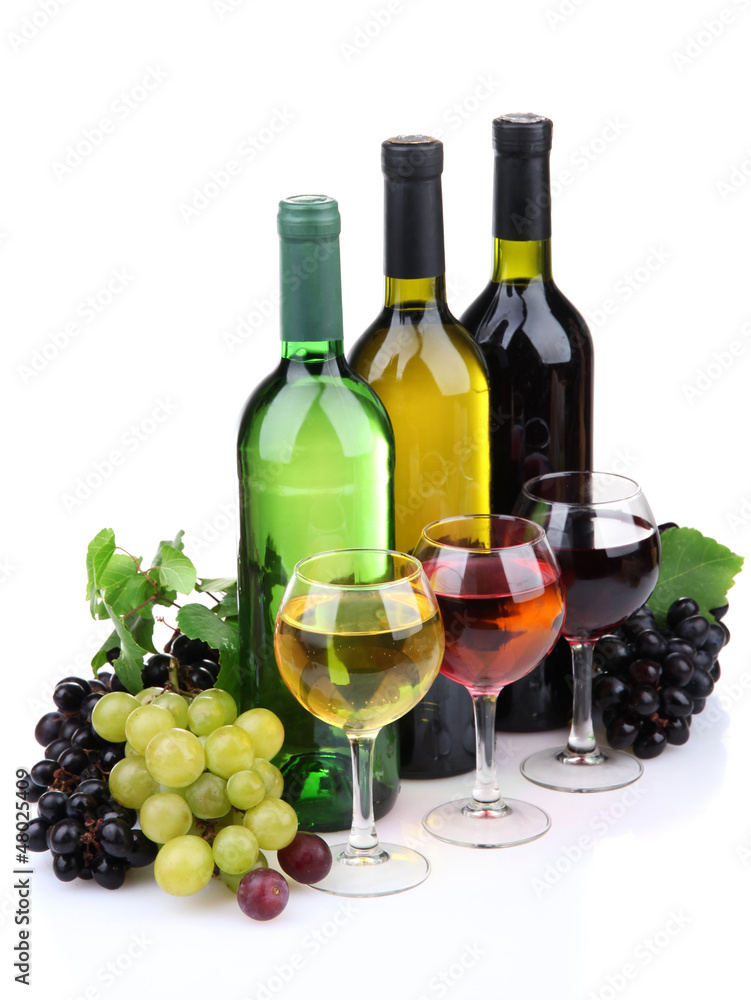 bottles and glasses of wine and assortment of grapes, isolated