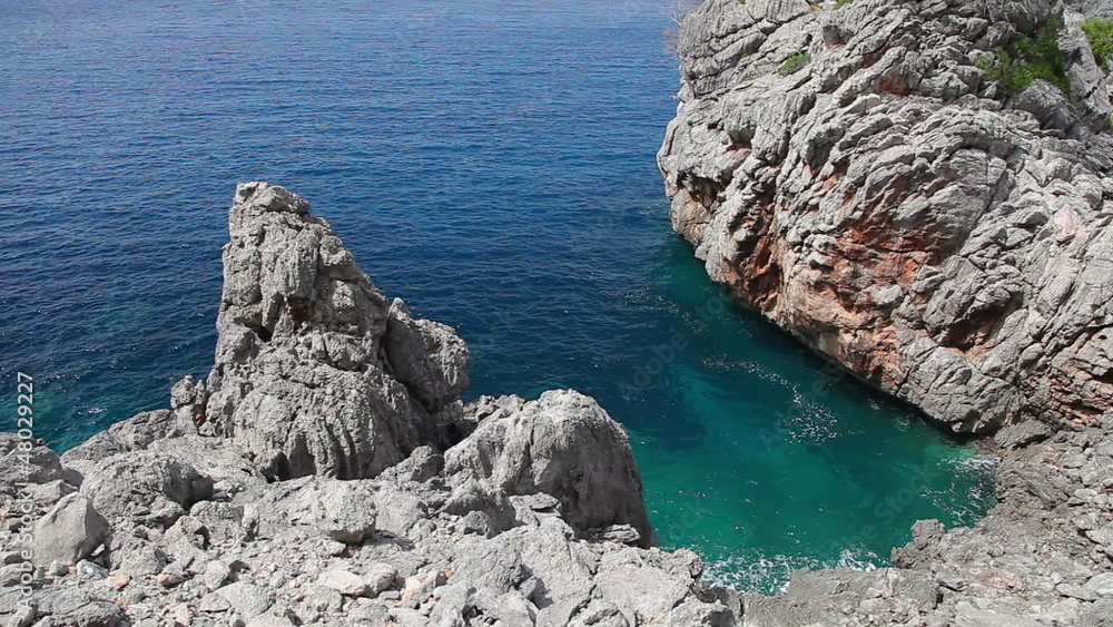 Clear crystal green water with rocks in sea, Mallorca, Spain Clear crystal green water with rocks in sea, Mallorca, Spain