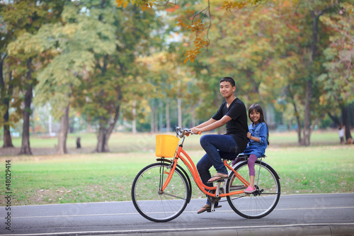 Brother and sister cycling bicycle at the park