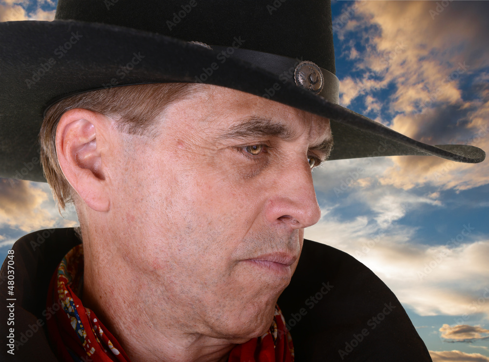 Close up of cowboy against sunset Close up of cowboy against sunset