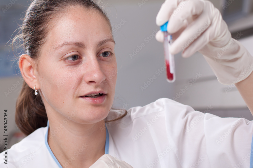 Holding test tube full of blood Holding test tube full of blood