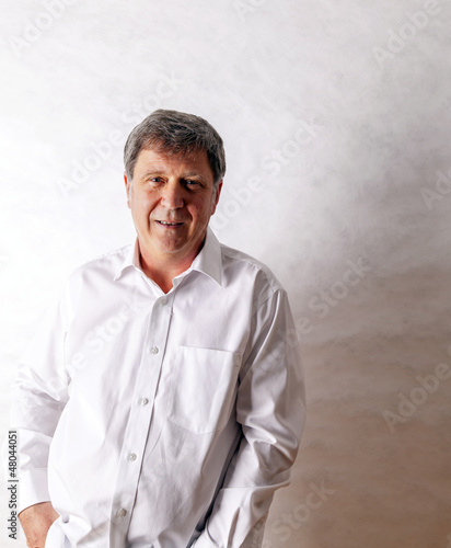 happy senior man standing gesturing against white background