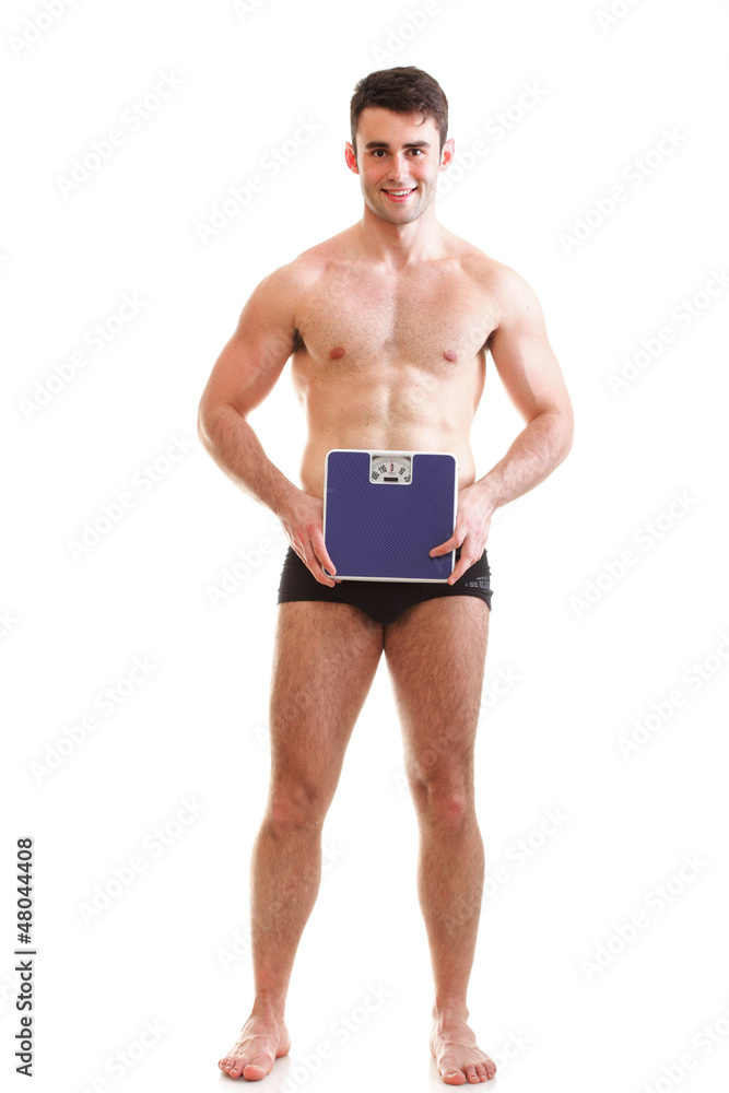 Healthy young man with a weight scale Isolated Healthy young man with a weight scale Isolated