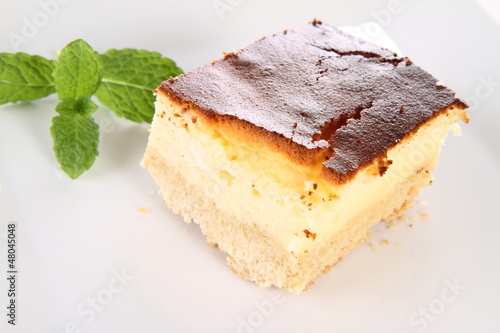 Piece of cheesecake decorated with mint
