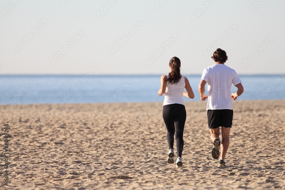 Man and woman running in the beach Man and woman running in the beach