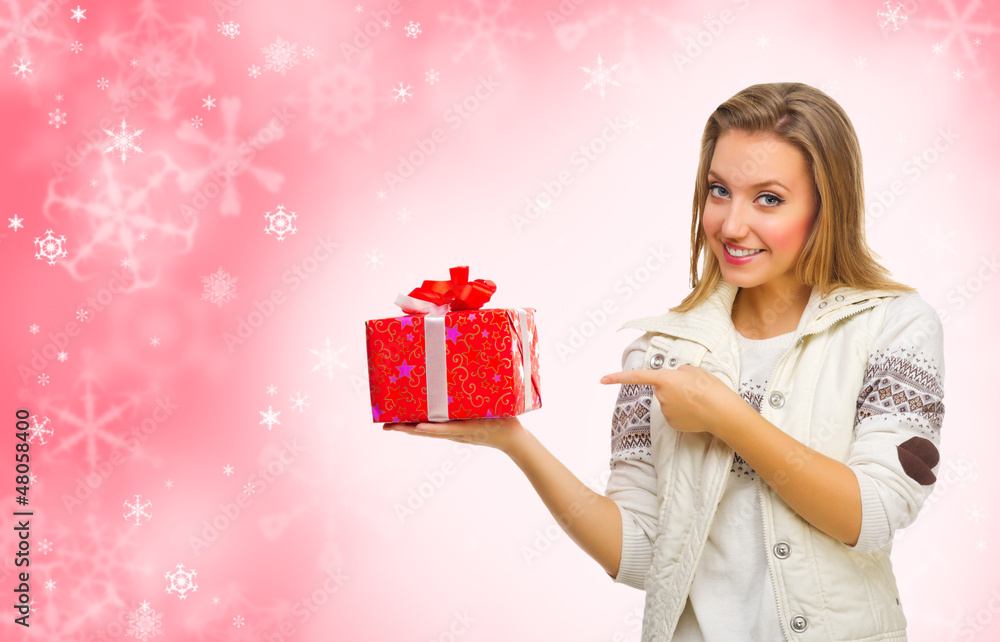 Young girl with gift box on winter background Young girl with gift box on winter background