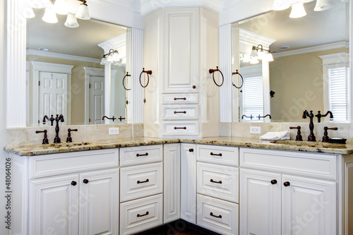 Luxury large white master bathroom cabinets with double sinks. © Iriana Shiyan