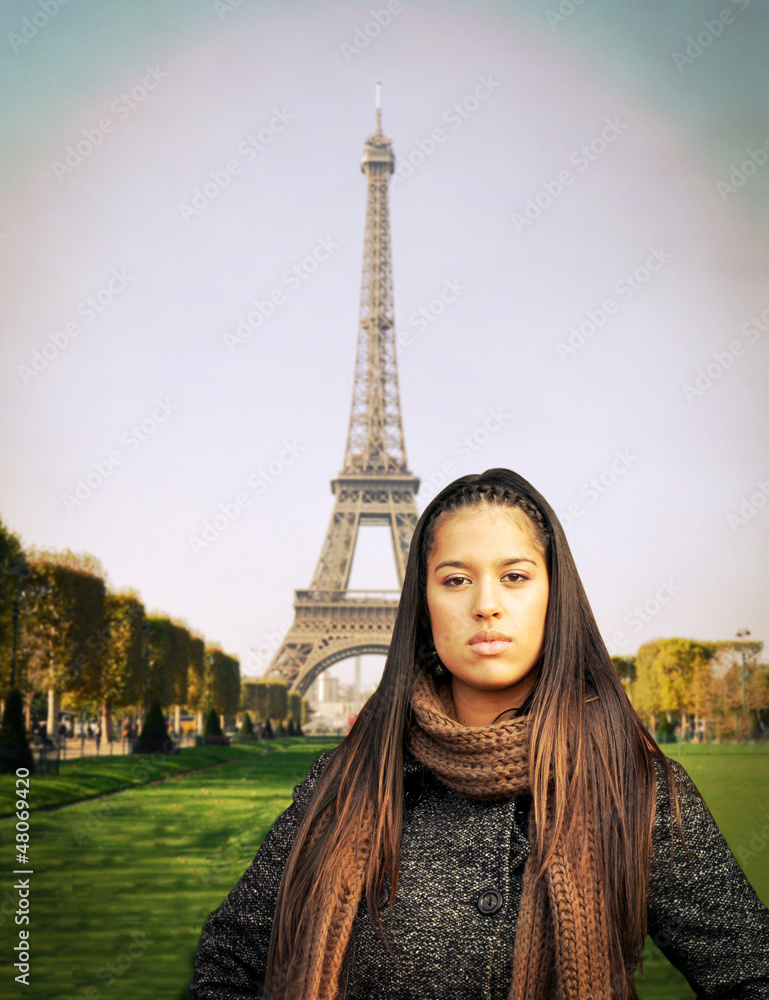Beautiful fashion model standing against Eiffel tower