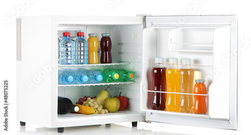 Canvastavla mini fridge full of bottles of juice, soda and fruit isolated