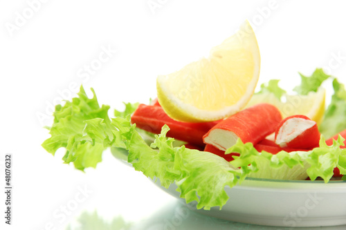 Crab sticks with lettuce leaves and lemon