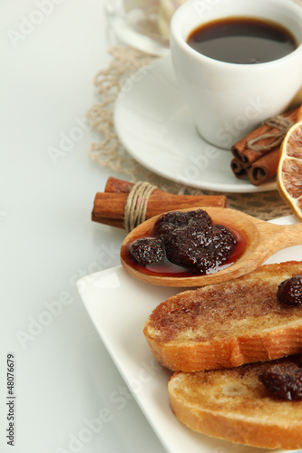 White bread toast with jam and cup of coffee, isolated on white