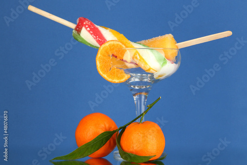 Two fruit juice ice in vase on blue background