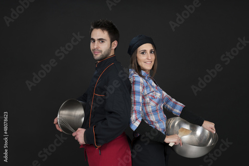 two young cooks, on black