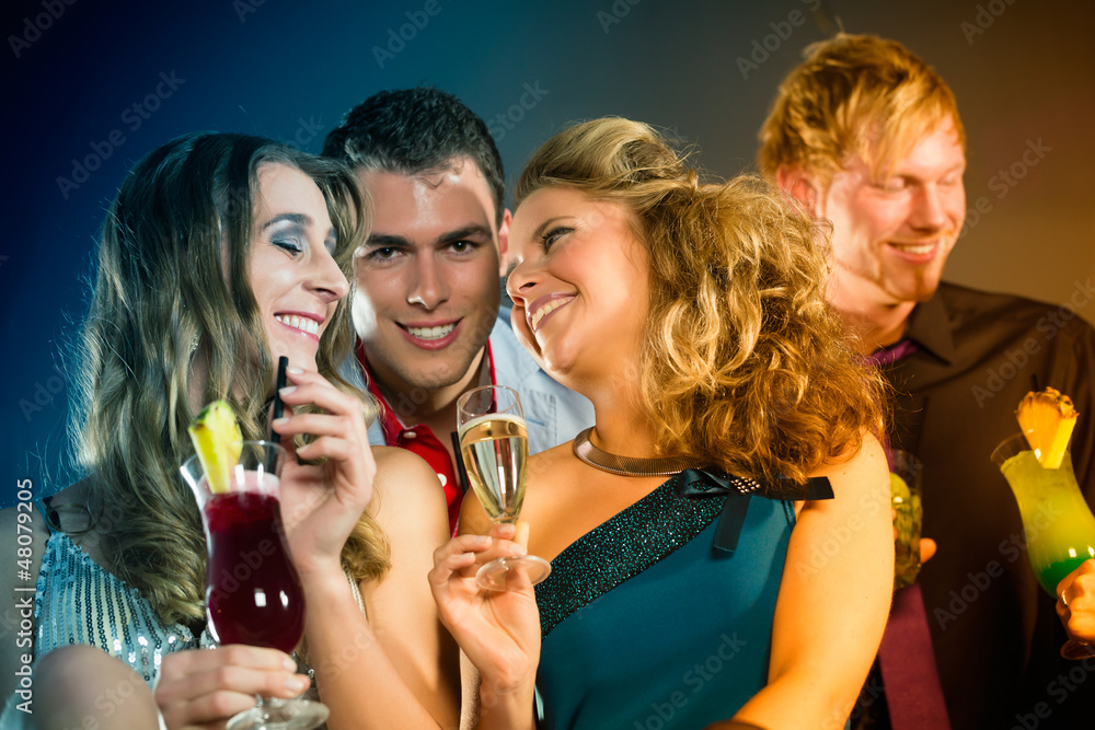 People in club or bar drinking cocktails People in club or bar drinking cocktails
