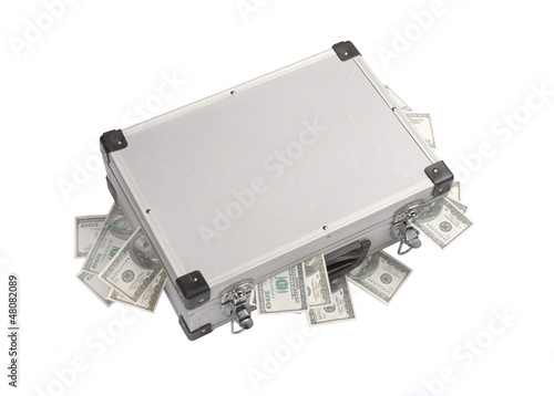 dollar banknotes sticking out of an aluminum suitcase