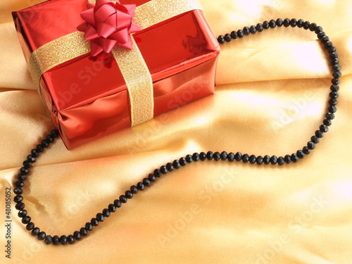 Gift box with ribbon isolated on gold background