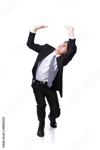 business man holding something heavy above head photo