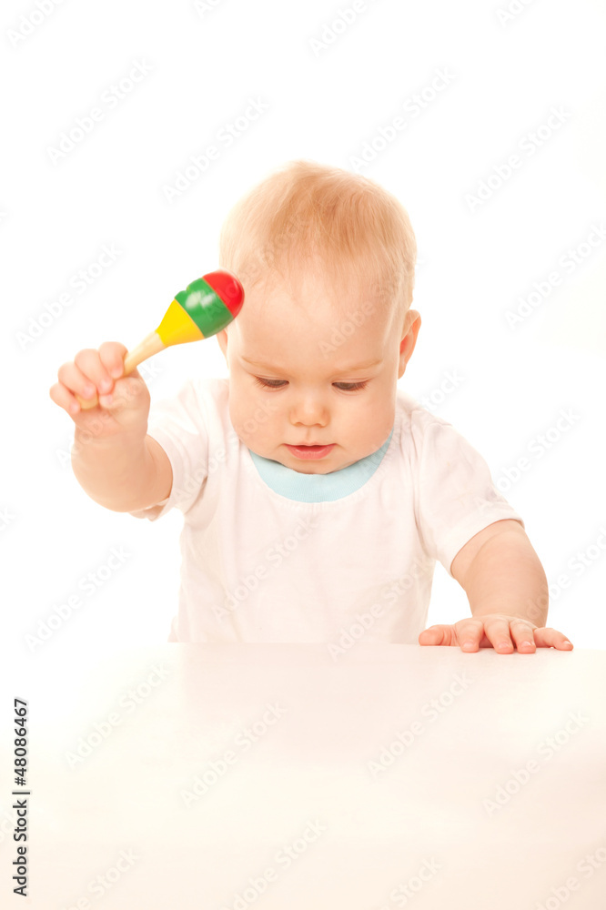 Baby knocking his rattle on the table. Baby knocking his rattle on the table.