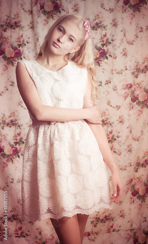 Young girl in pink dress on background.