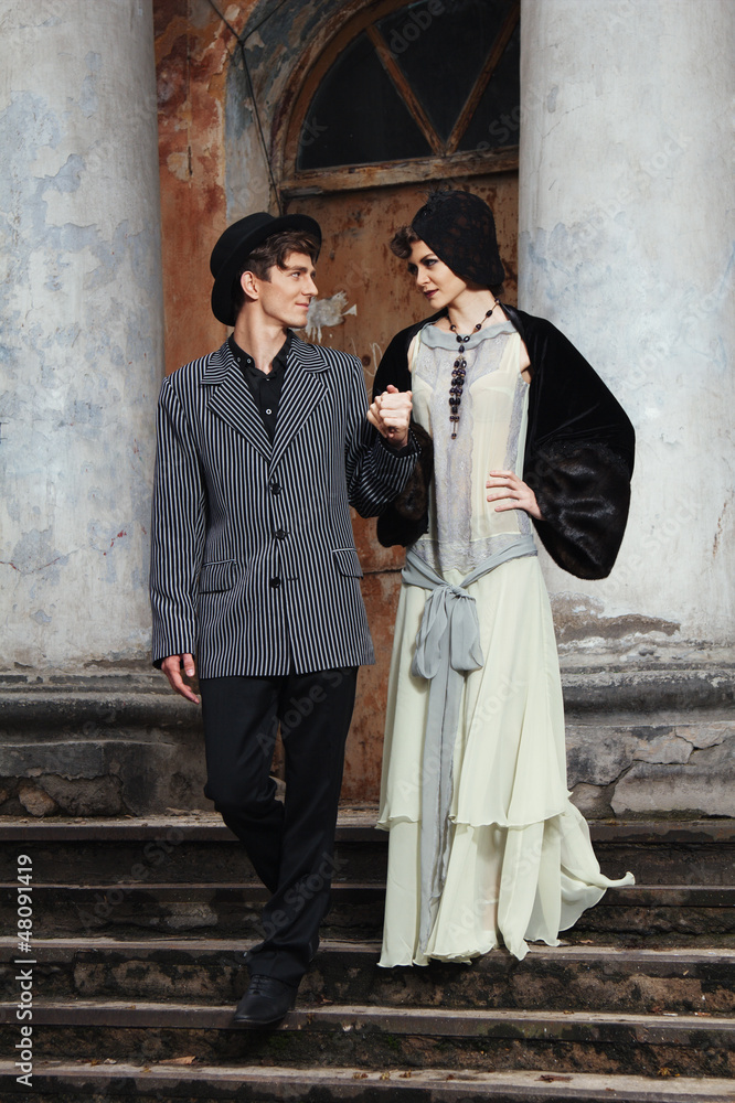 Retro styled fashion portrait of a young couple. Clothing and ma Retro styled fashion portrait of a young couple. Clothing and ma