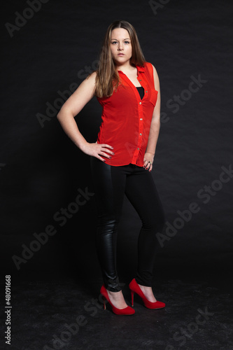 Pretty brunette girl against dark background. Studio shot. © ysbrandcosijn