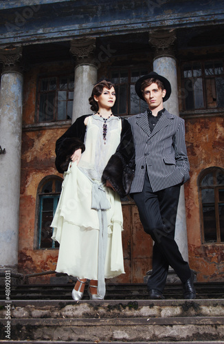 Retro styled fashion portrait of a young couple. Clothing and ma